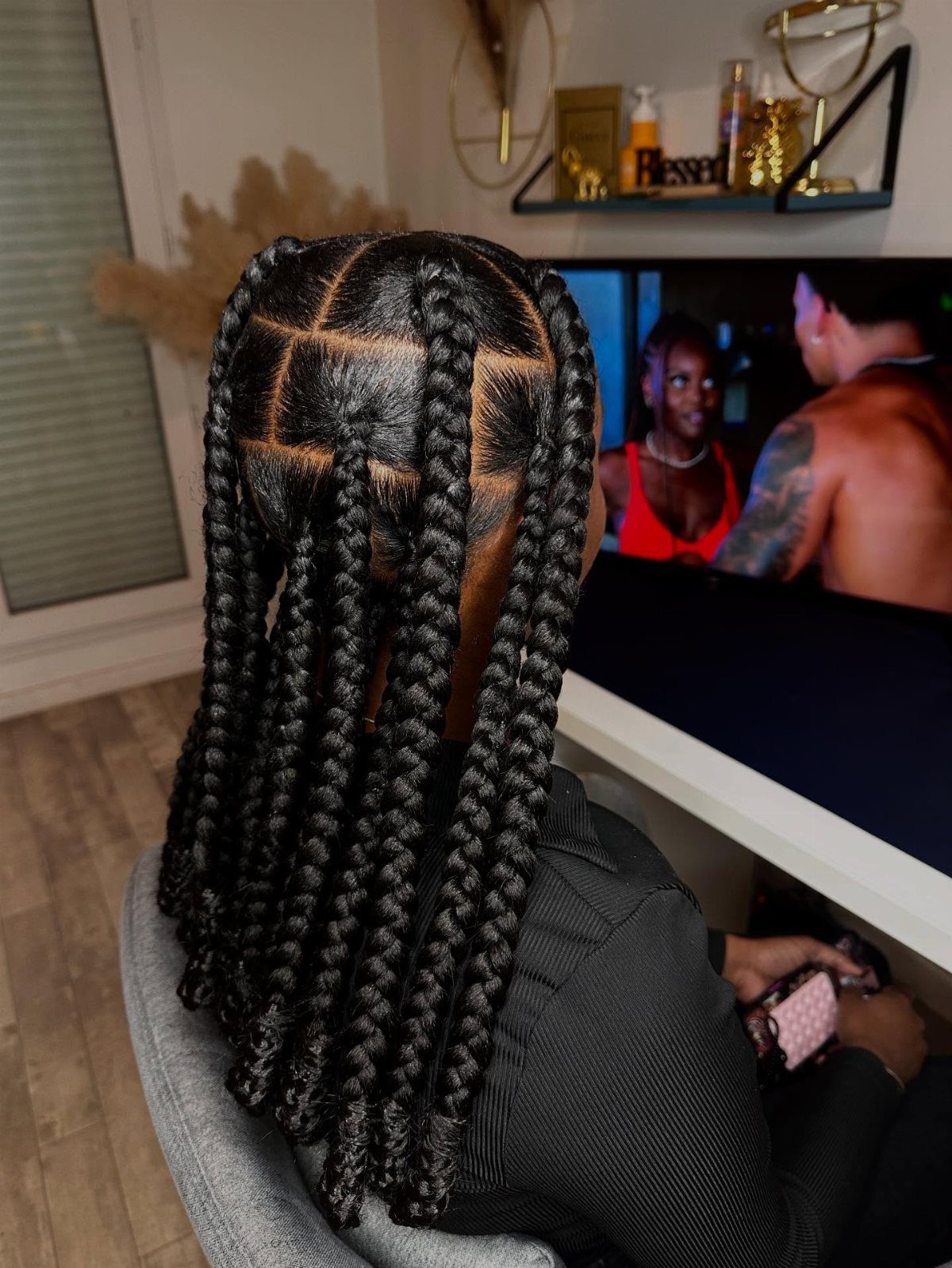 12 Braids Hairstyles: 16 Ideas From Box Braids to Cornrows 1 Long black box braids with square scalp partitions on a person's head.