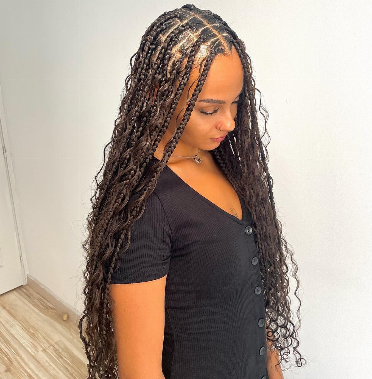 12 Braids Hairstyles: 16 Ideas From Box Braids to Cornrows 2 Woman with long dark brown goddess braids and curly extensions wearing black shirt
