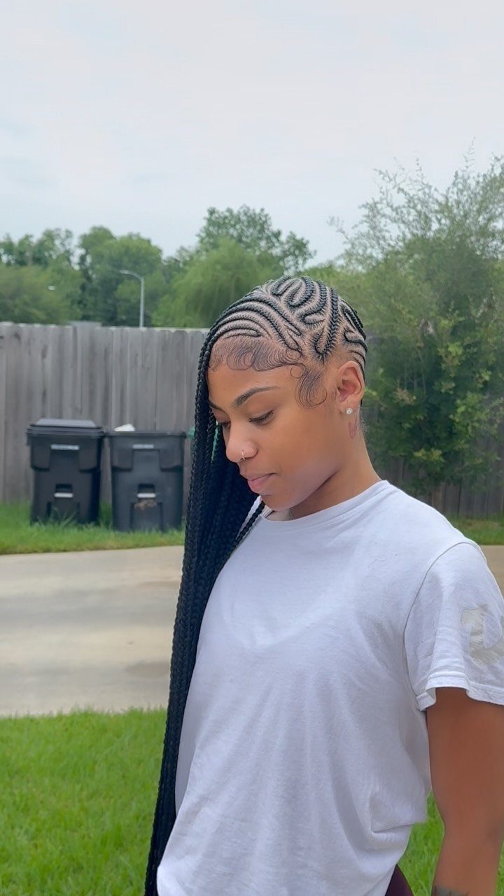 12 Braids Hairstyles: 16 Ideas From Box Braids to Cornrows 9 Woman with long black side-swept lemonade braids wearing a white t-shirt outdoors.