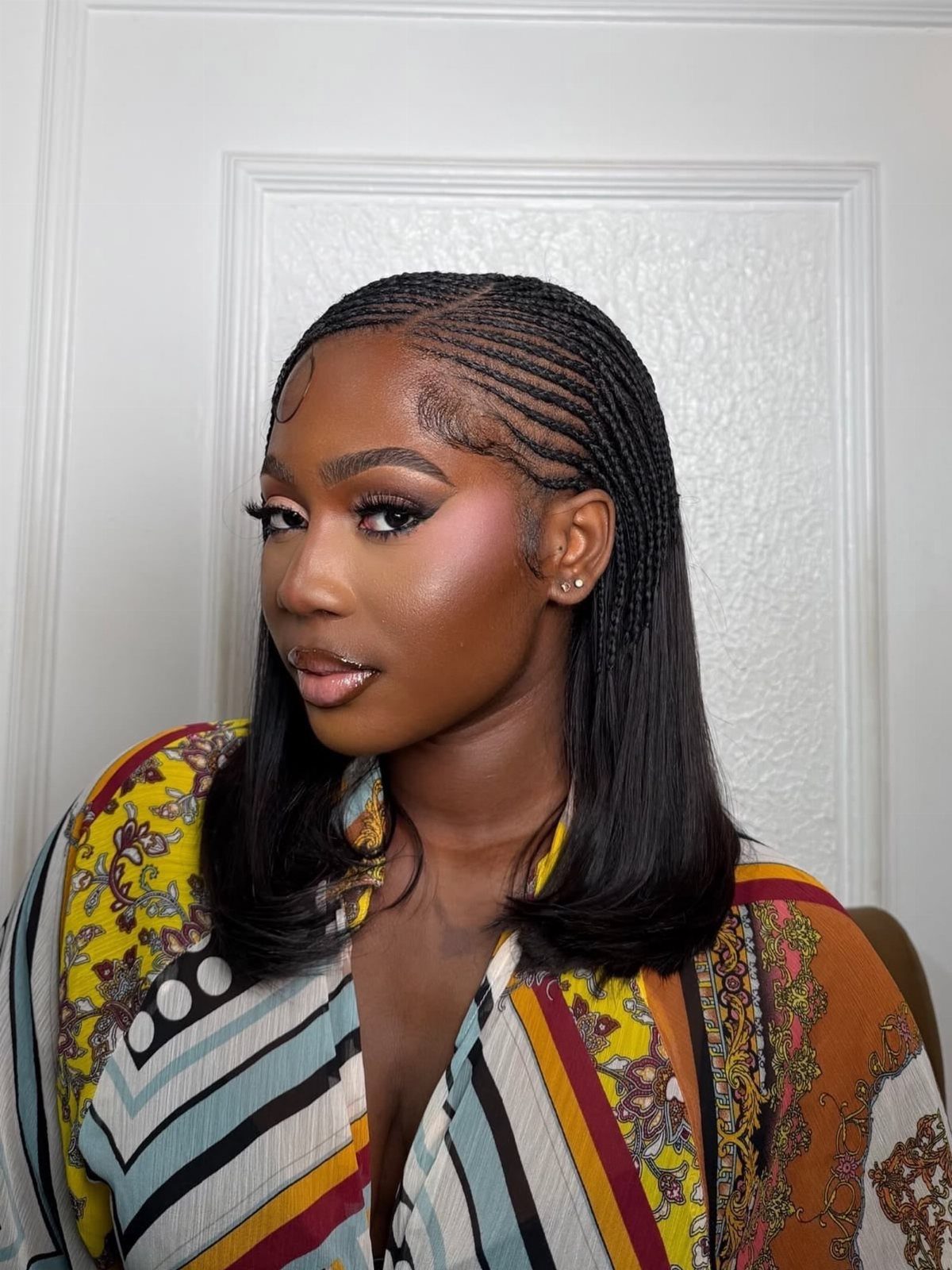 16 Big Cornrow Hairstyles for Bold, Standout Looks 13 Woman with cornrows on top and straight sew-in hair at the bottom.