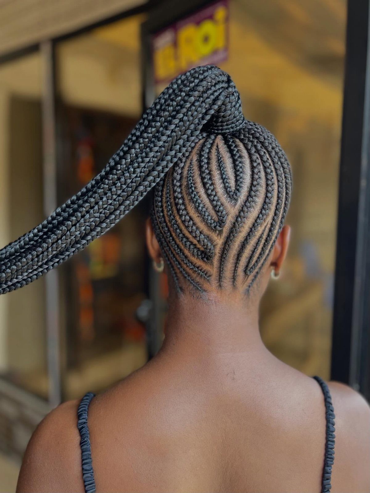 16 Big Cornrow Hairstyles for Bold, Standout Looks 10 Curved cornrows leading into a high, long braided ponytail on a person.