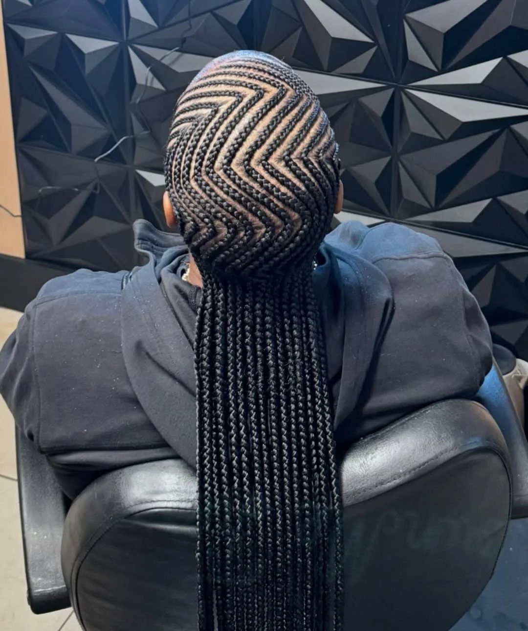 16 Big Cornrow Hairstyles for Bold, Standout Looks 3 Zig-zag cornrow hairstyle on a person with long black braids from behind.