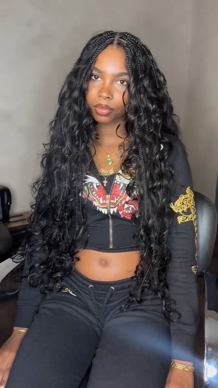 31 Black Hair Natural Hairstyles for Every Length 21 Woman with long black hair featuring braids and voluminous curls wearing black loungewear.