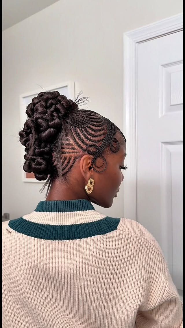 31 Black Hair Natural Hairstyles for Every Length 27 Woman with intricate cornrow braids styled into a large, textured high bun.