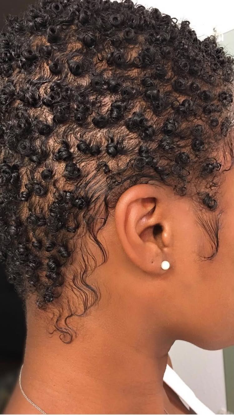 31 Black Hair Natural Hairstyles for Every Length 17 Short black natural hair with defined, glossy tight curls in a profile view.