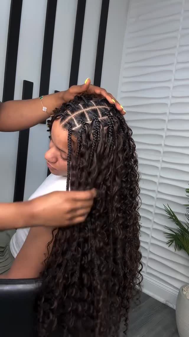15 Braid Hairstyles for Thick Hair, From Bubble to Boho 6 Woman receiving bohemian braids with loose curly strands and braided scalp sections.