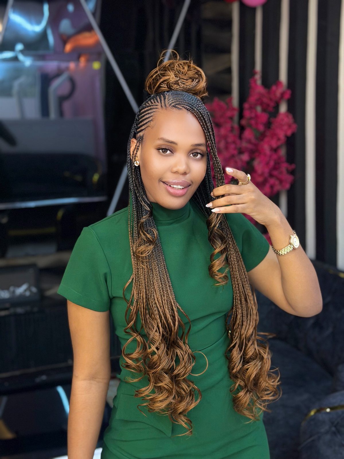 15 Braid Hairstyles for Thick Hair, From Bubble to Boho 8 Woman with cornrow braided bun and long curly brown braids wearing green dress
