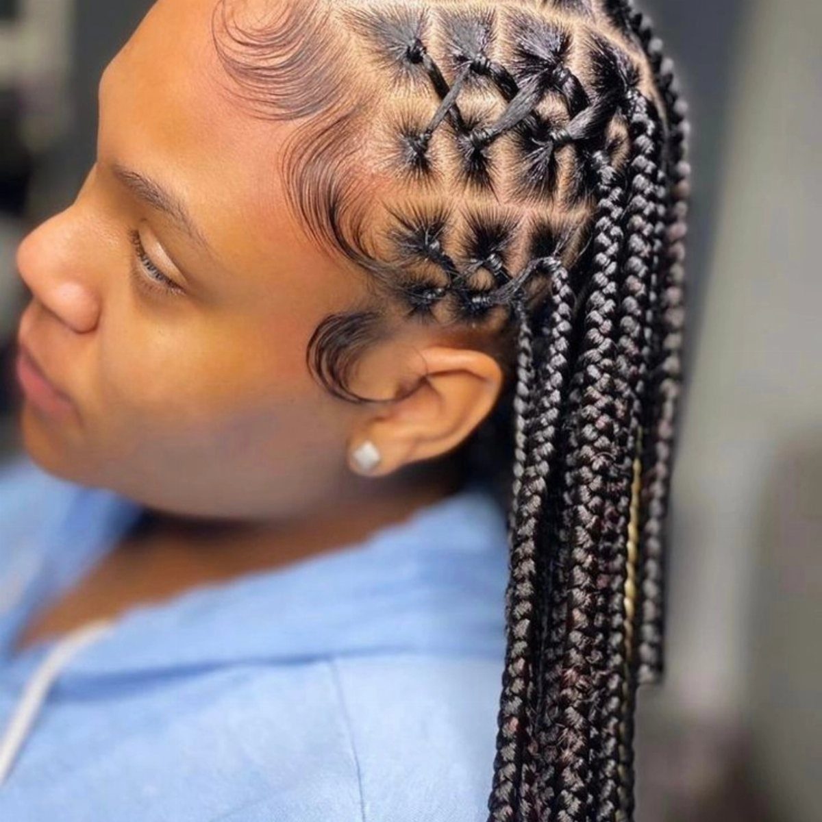 15 Braid Hairstyles for Thick Hair, From Bubble to Boho 4 Woman with dark hair styled in criss-cross goddess braids and long extensions.