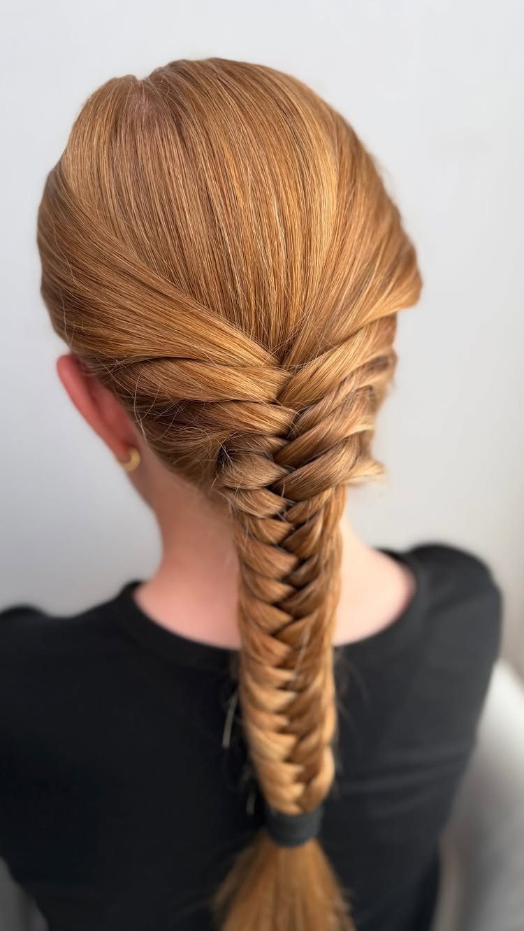 15 Braid Hairstyles for Thick Hair, From Bubble to Boho 5 Strawberry blonde hair styled into a long, thick fishtail braid from behind.