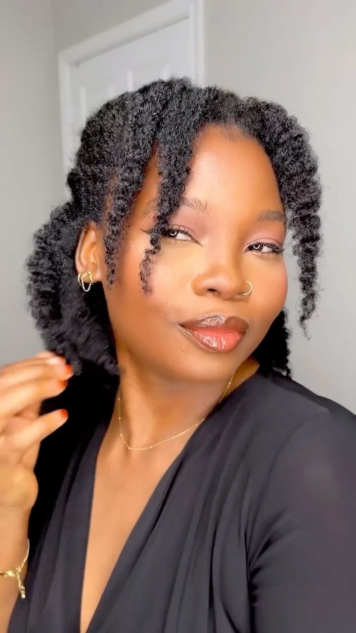 How to Style a Braid Out Afro: 5 Ideas for Every Length 3 Woman with a textured braid out afro hairstyle wearing a black top.