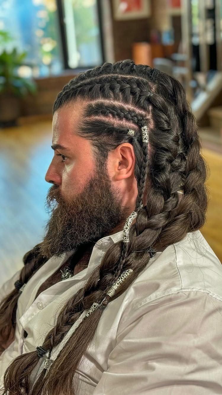 11 Braided Mens Hairstyles: Cornrows, Box Braids and More 10 Man with a full beard and long brown hair in intricate braided hairstyles.