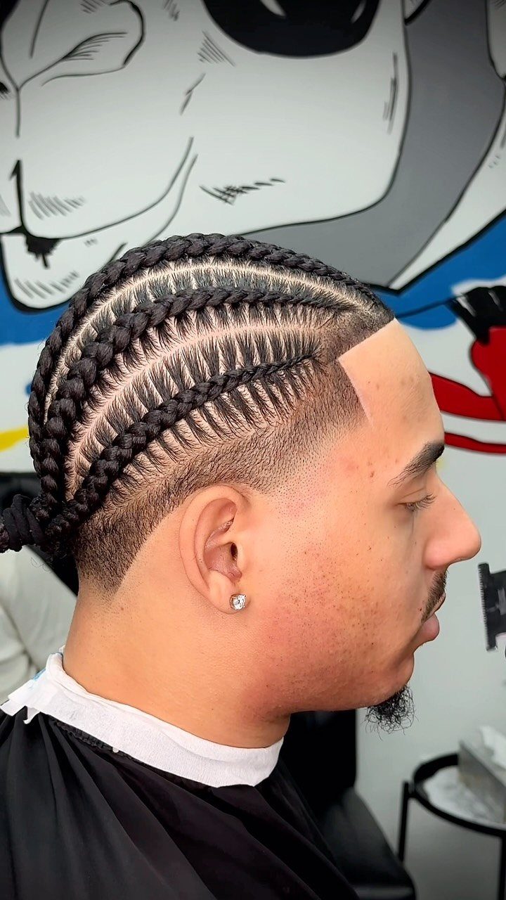 11 Braided Mens Hairstyles: Cornrows, Box Braids and More 4 Man with cornrow braids on top and a clean skin fade haircut.