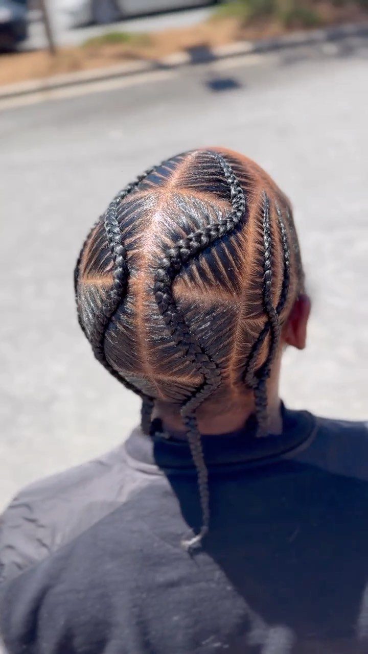 11 Braided Mens Hairstyles: Cornrows, Box Braids and More 8 Man with dark hair in geometric stitch braids forming a star pattern.