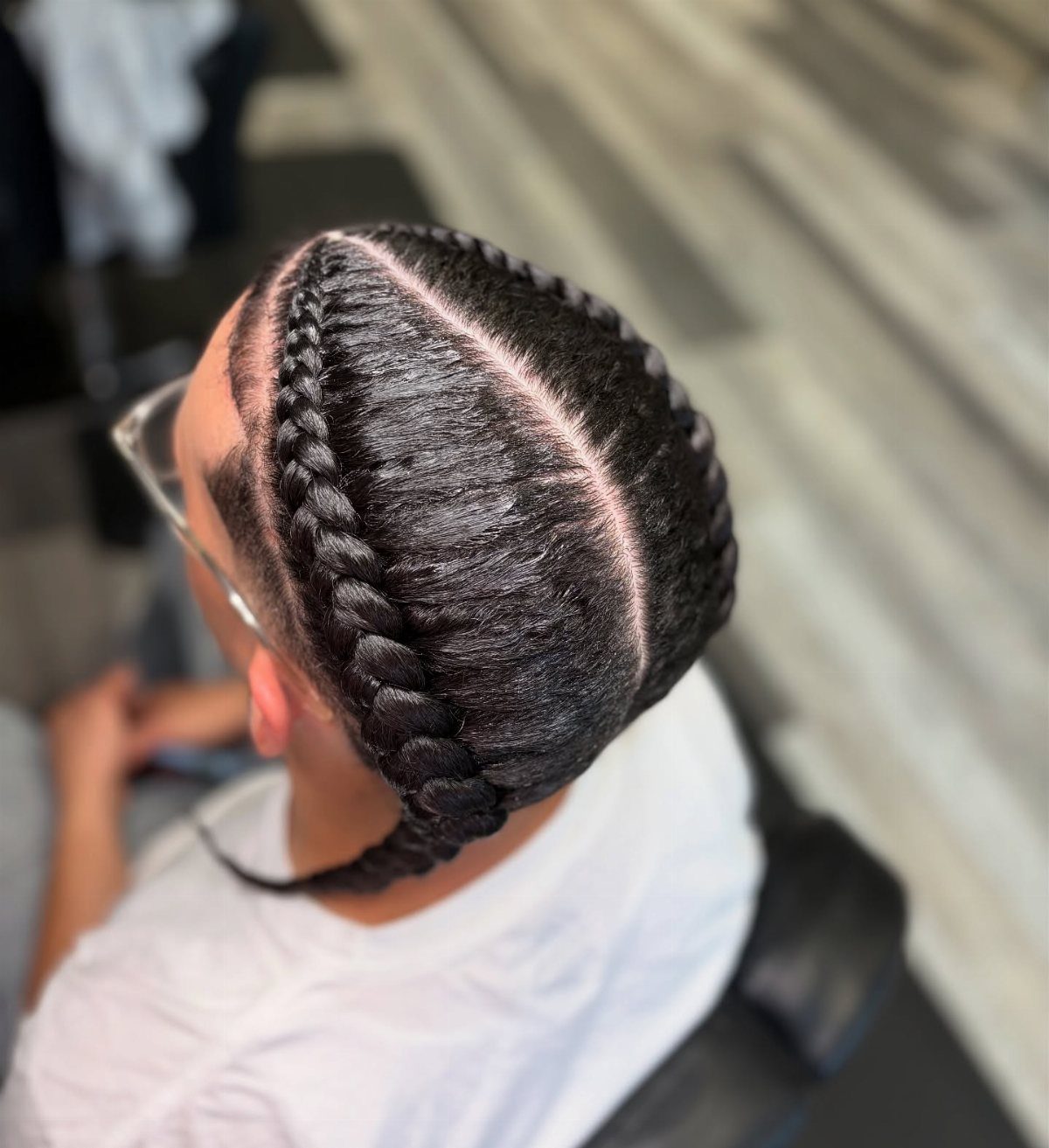11 Braided Mens Hairstyles: Cornrows, Box Braids and More 6 Man with two thick Dutch braids running along the sides of his head.