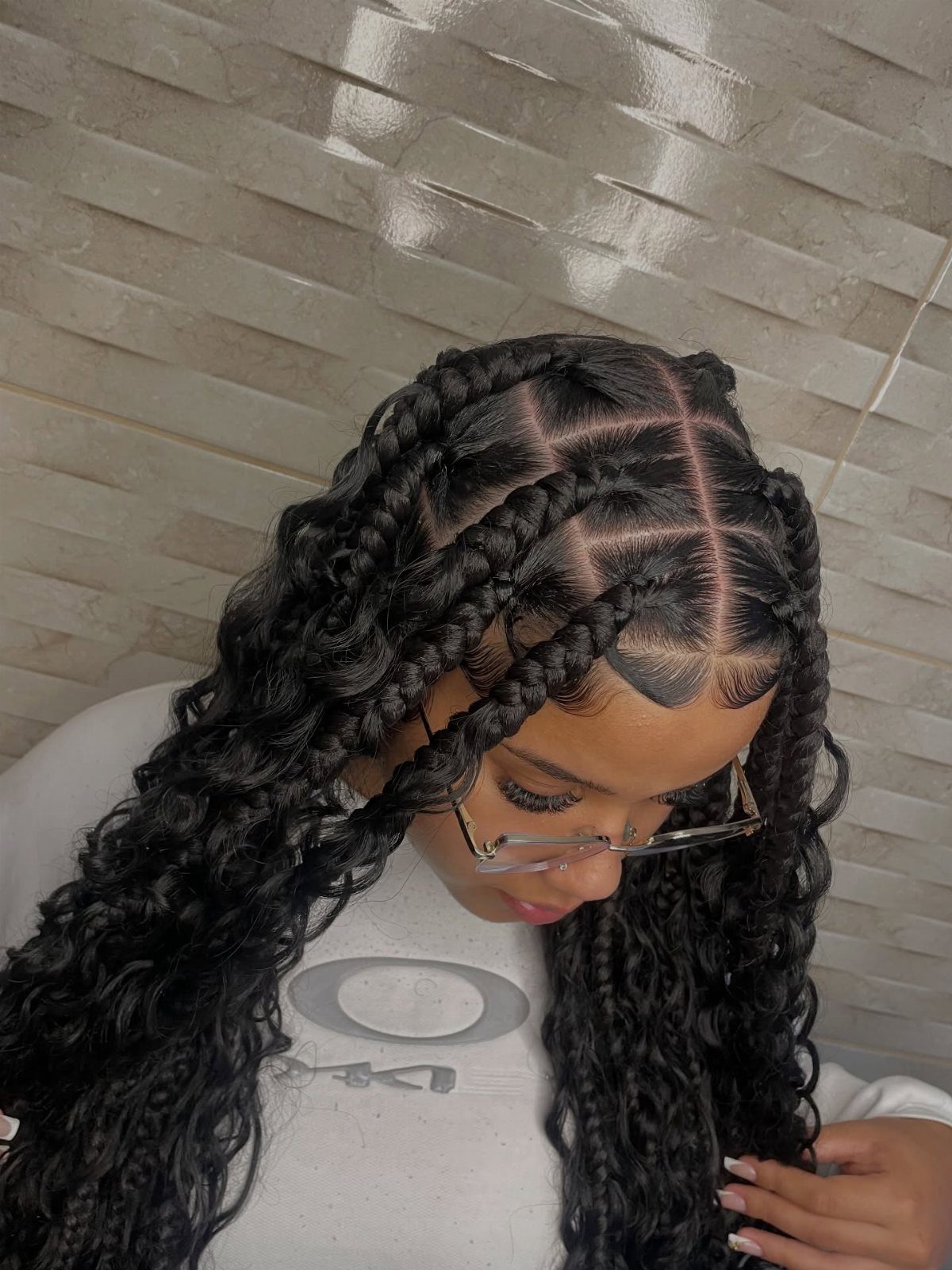 16 Braids Going Back with Curls: Styles to Try 8 Woman with thick black chunky braids transitioning into long, voluminous curly hair ends.