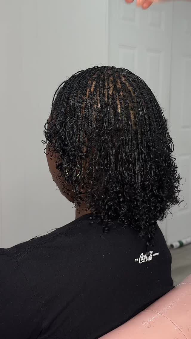16 Braids Going Back with Curls: Styles to Try 7 Black micro braids transitioning into tight curls at the ends on a person.