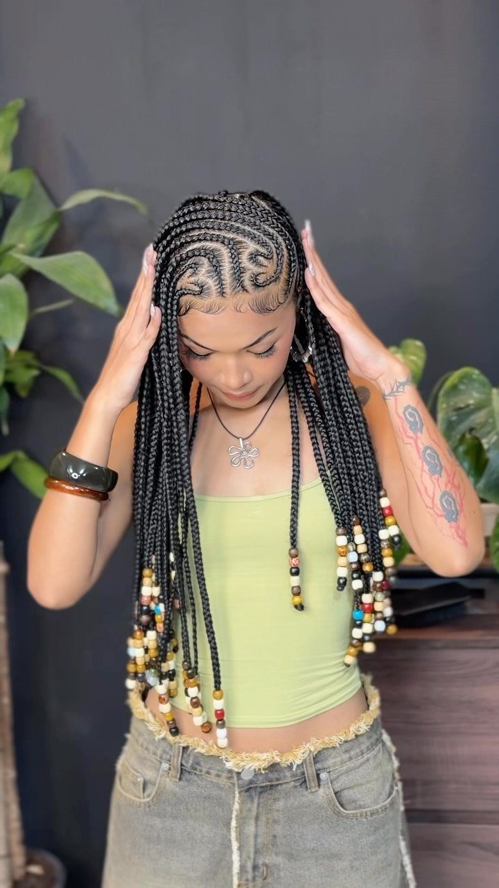 9 Braids with Natural Hair Only: Styles Without Extensions 5 Woman with Fulani braids and colorful beads wearing a lime green tank top.