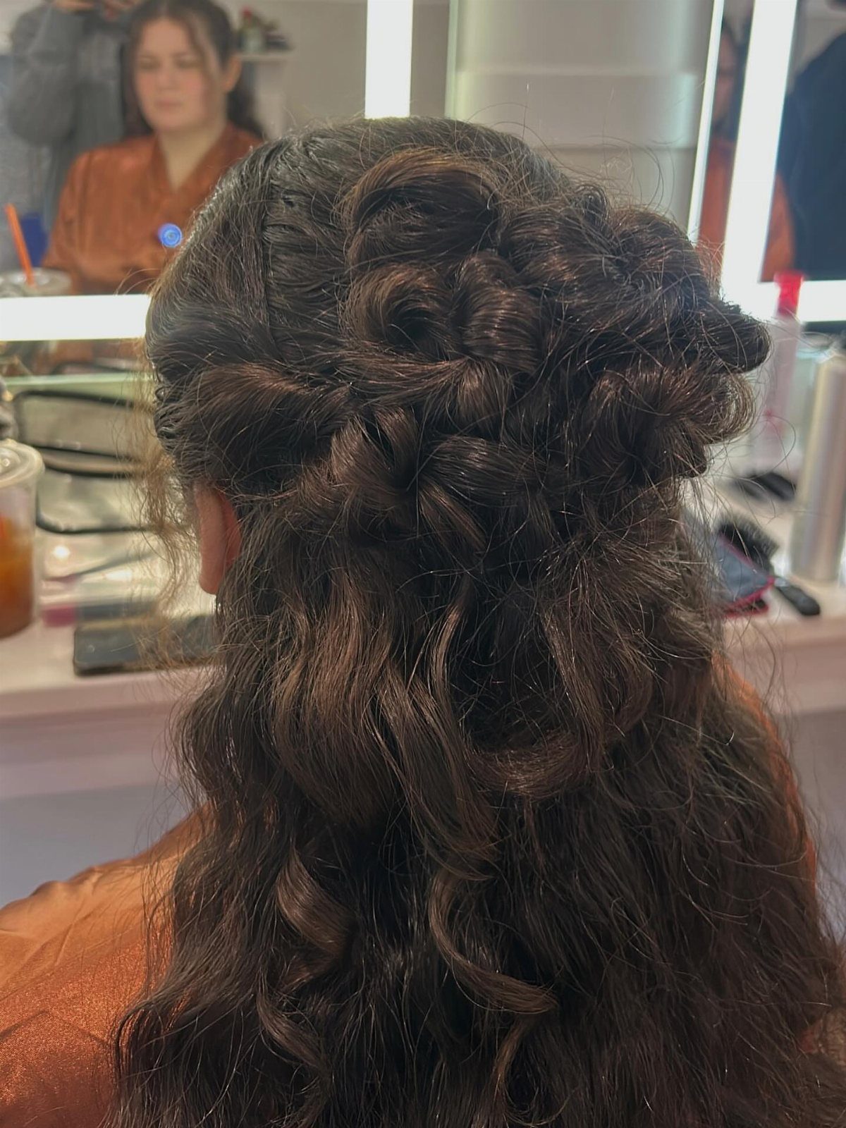 8 Ideas for a Bun with Curls, From High to Low 6 Curly brown hair styled into a textured bun with long cascading curls.