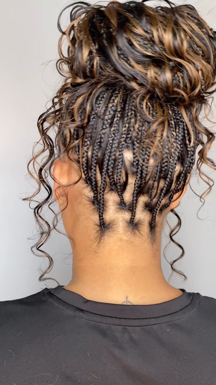 Buns for Curly Hair: 7 Ideas, From Messy to Floral 6 High bun with braids and loose curls on dark brown and blonde hair.