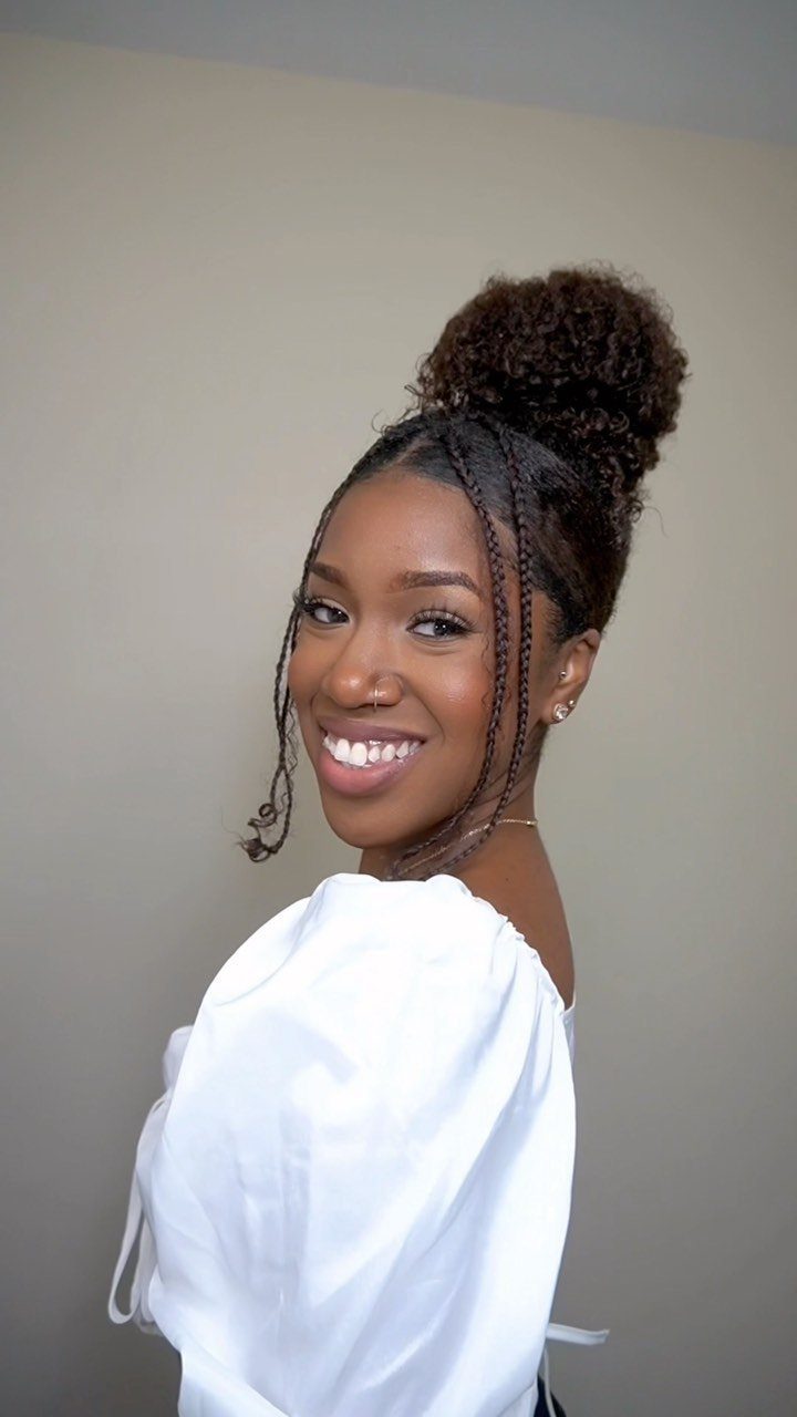 Buns for Curly Hair: 7 Ideas, From Messy to Floral 2 Woman with curly hair styled in a high bun and face-framing braids.