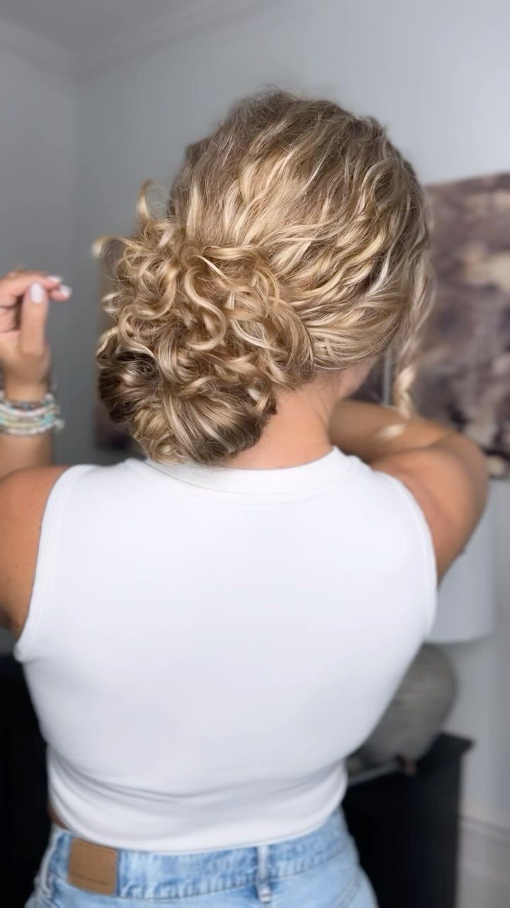Buns for Curly Hair: 7 Ideas, From Messy to Floral 3 Blonde curly hair styled into a low textured bun at the neck