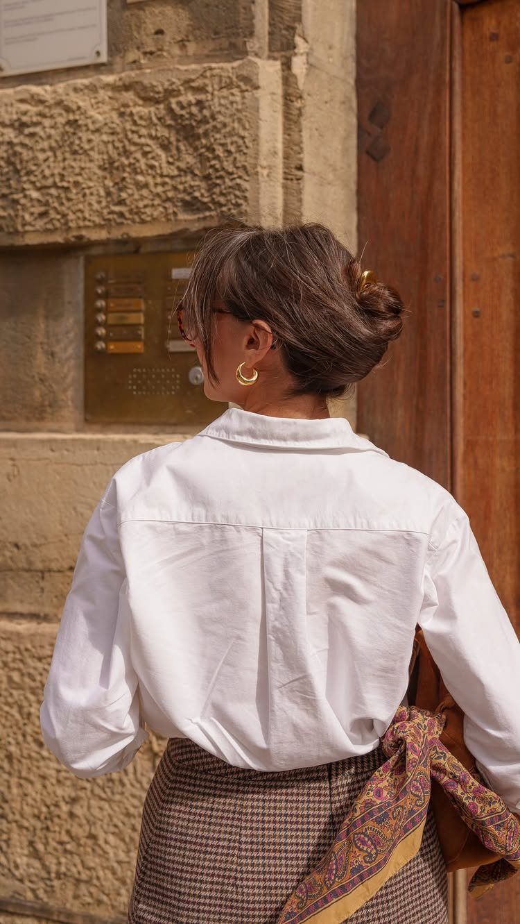 9 Business Casual Hairstyles for Women at the Office 1 Woman from behind with a low twisted bun and white business casual shirt.