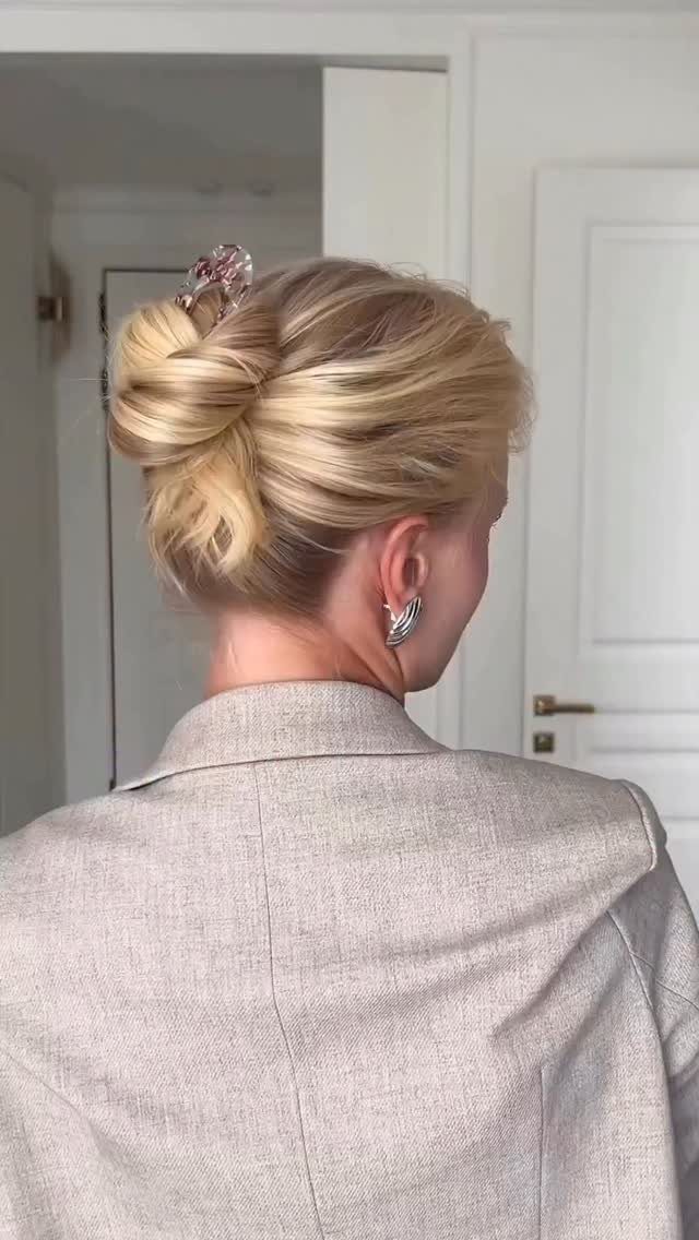 9 Business Casual Hairstyles for Women at the Office 8 Blonde woman with a twisted updo secured by a clip wearing a beige blazer.