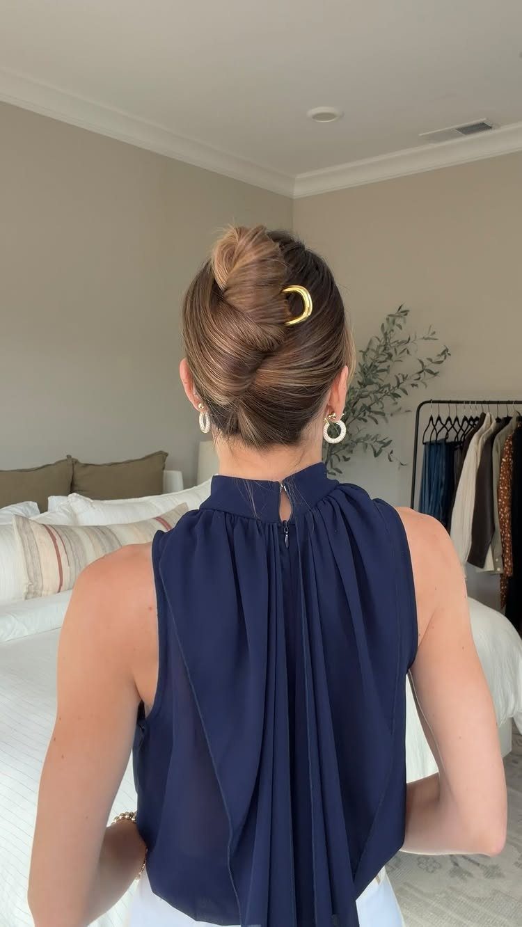 9 Business Casual Hairstyles for Women at the Office 3 Woman with a French twist hairstyle secured by a gold crescent hair clip.