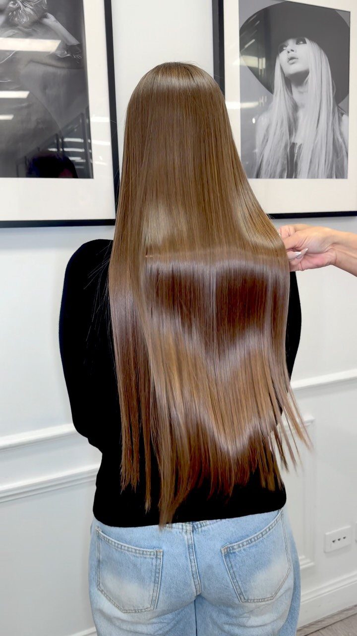 9 Business Casual Hairstyles for Women at the Office 6 Long straight glossy brown hair seen from behind on a woman.