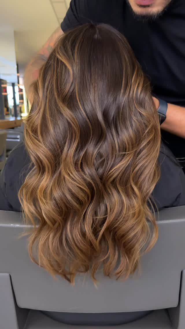Caramel Mousse Hair Ideas: 5 Looks from Balayage to Highlights 2 Long wavy hair with a dark brown to caramel balayage color transition.
