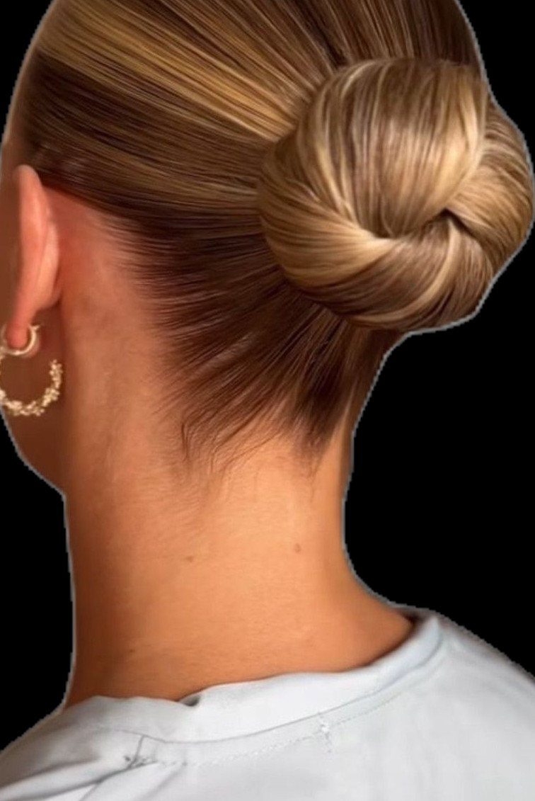 7 Clean Look Hair Ideas for Sleek Buns and Ponytails 3 Blonde hair styled in a polished, slicked-back high bun with gold hoop earrings.