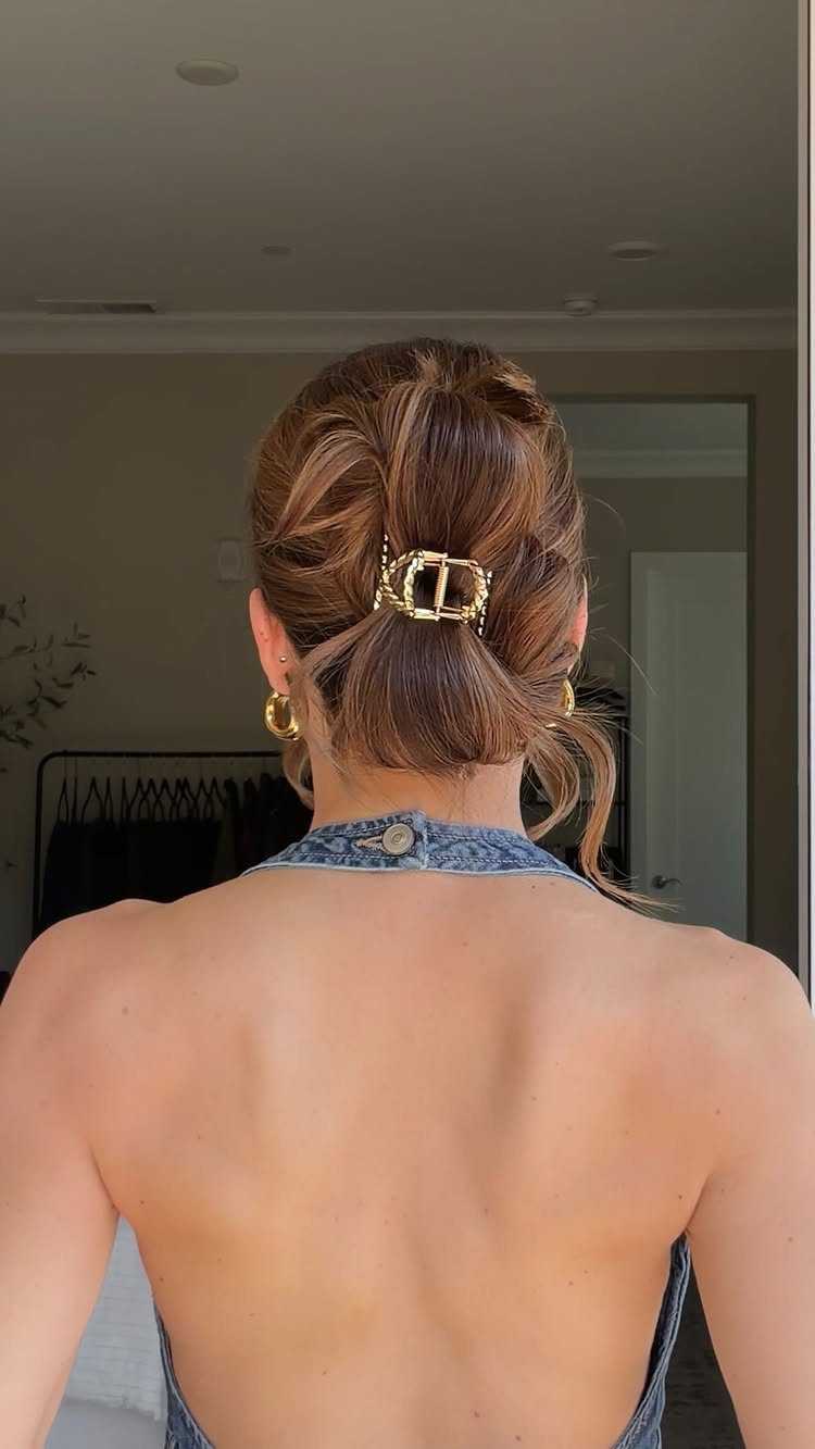 10 Clip Up Hairstyles with Claw Clips and Accent Clips 1 Brown hair styled in a low twisted bun with a gold claw clip.