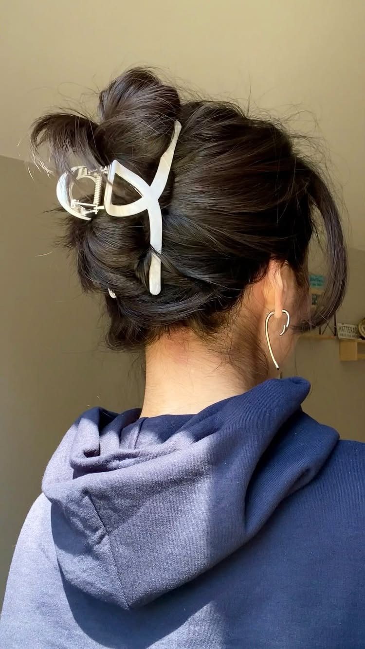 10 Clip Up Hairstyles with Claw Clips and Accent Clips 8 Dark hair styled in a messy bun secured with a white claw clip