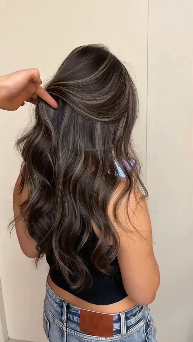 Color Hair for Morena: 8 Shades That Flatter Brown Skin 1 Long wavy dark brown hair with cool ash brown highlights shown from behind.