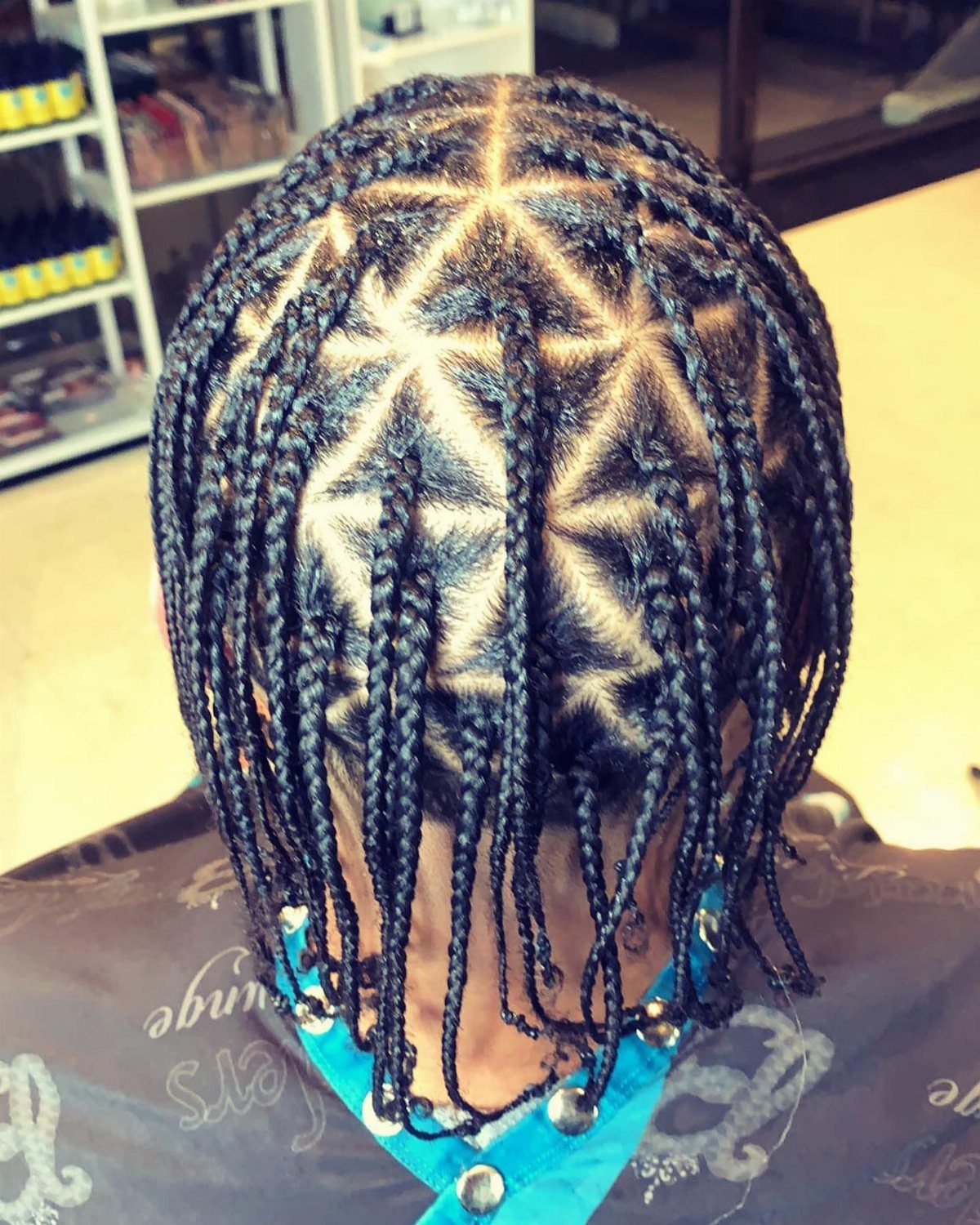 Cornrows Braids with Curls: 13 Ideas for Every Style 4 Black hair styled in cornrows forming triangle patterns with hanging box braids.