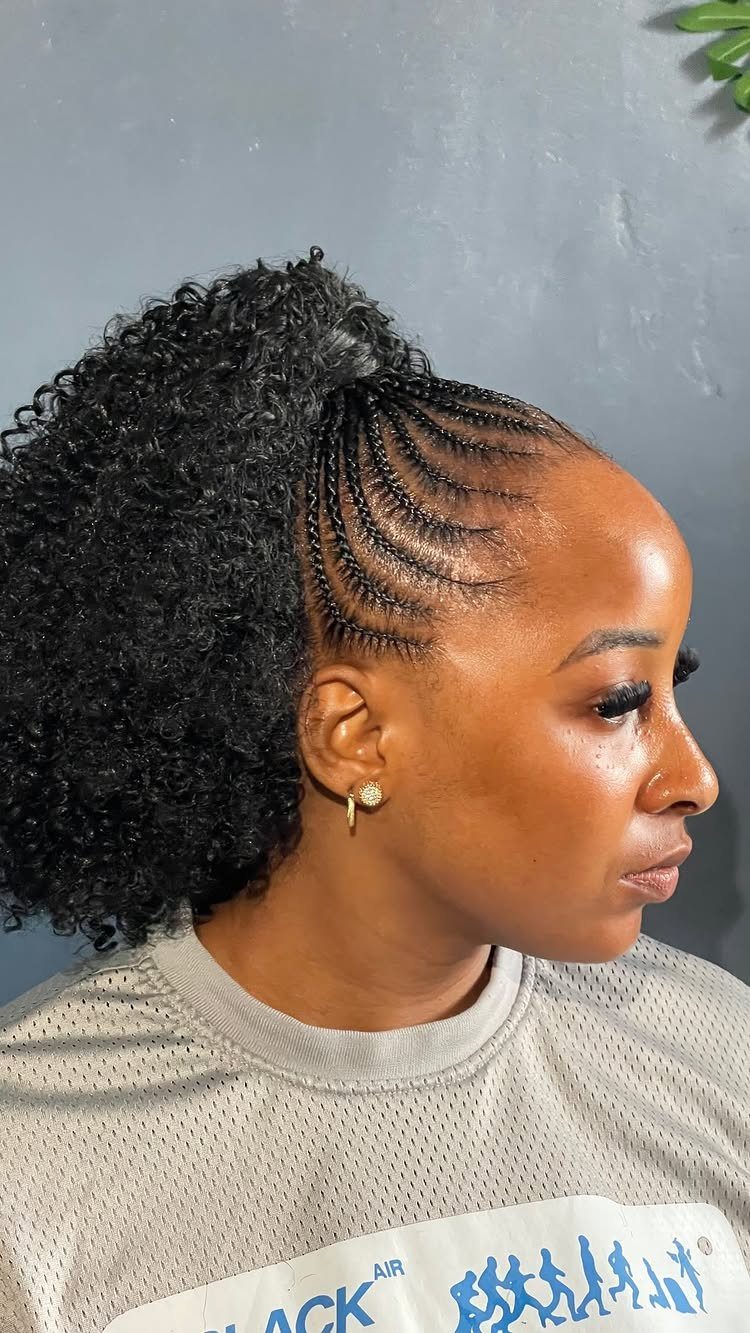 Cornrows Braids with Curls: 13 Ideas for Every Style 12 Woman with cornrow braids transitioning into a large, curly black ponytail hairstyle.