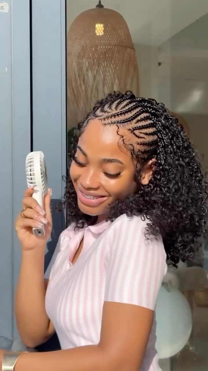 Cornrows Braids with Curls: 13 Ideas for Every Style 8 Woman with cornrow braids transitioning into voluminous loose curly black hair.