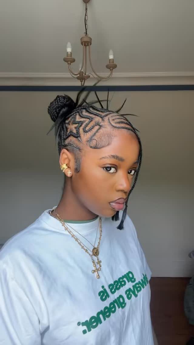 Cornrows Braids with Curls: 13 Ideas for Every Style 3 Woman with zig-zag cornrow braids styled into a high bun wearing white t-shirt