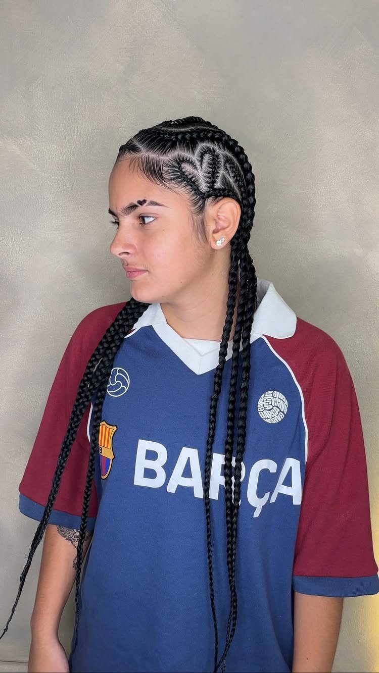 Person with cornrows transitioning into long box braids wearing a Barcelona jersey.