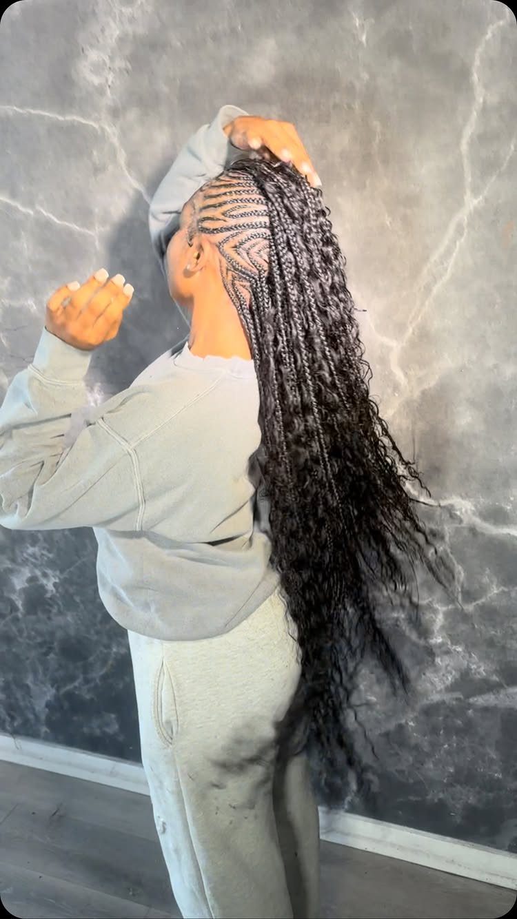 Woman with long dark braids transitioning from cornrows to curly box braids.