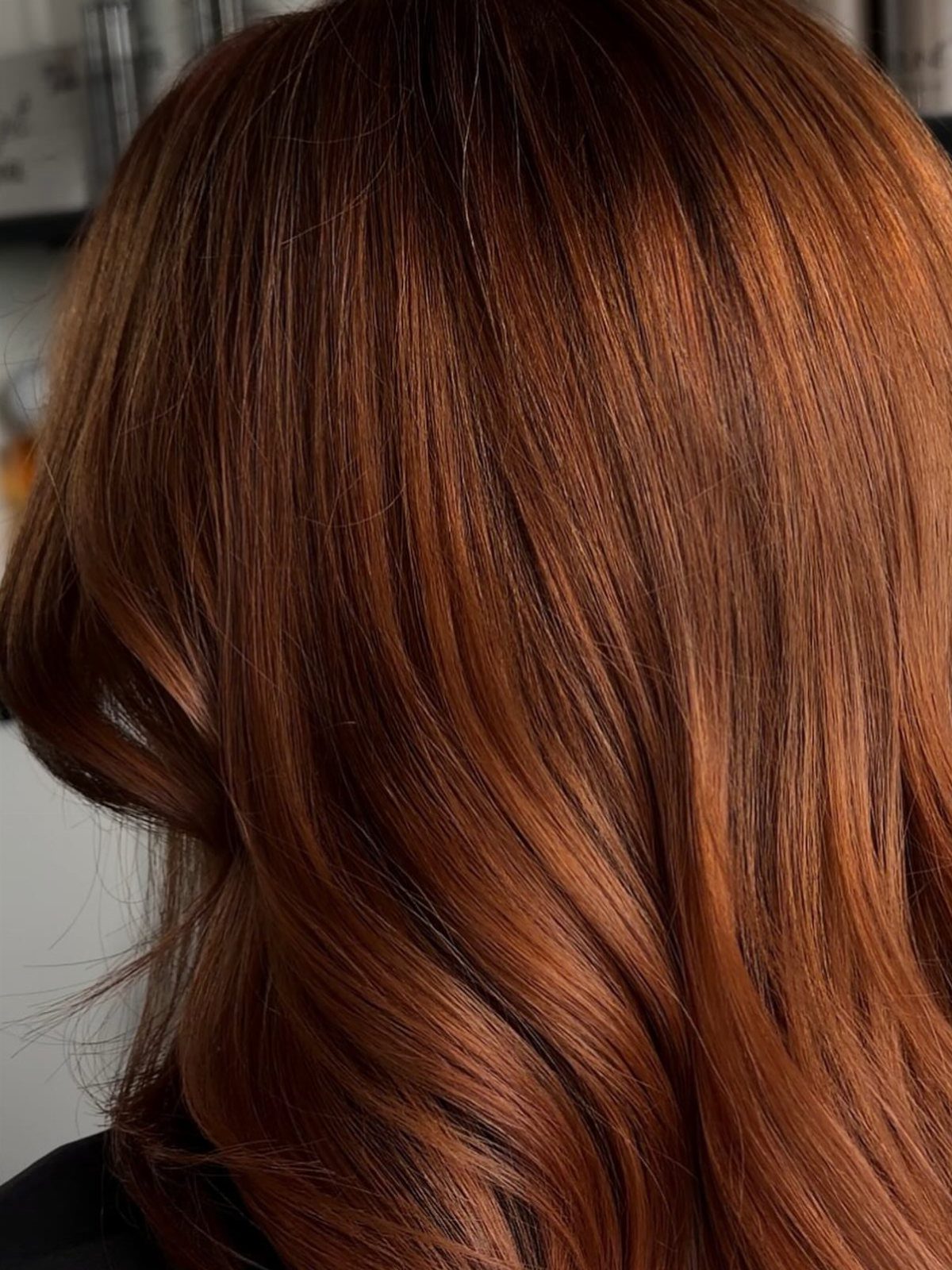 Cowboy Hair Color Ideas: 6 Copper Shades to Try 5 Long wavy copper-red hair with warm golden highlights viewed from the back.