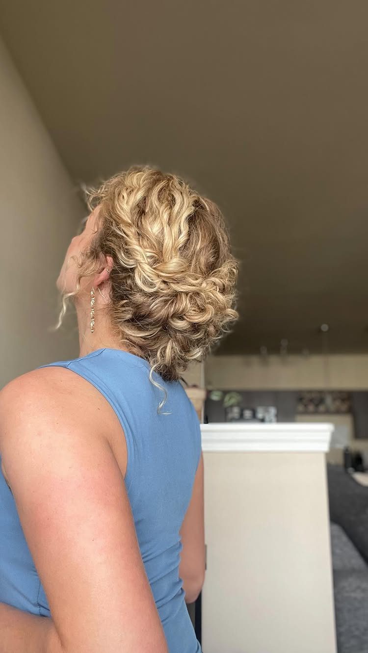 Curly Hair Design: 10 Ideas for Every Length and Texture 8 Blonde curly hair styled in a loose low bun with soft curls.