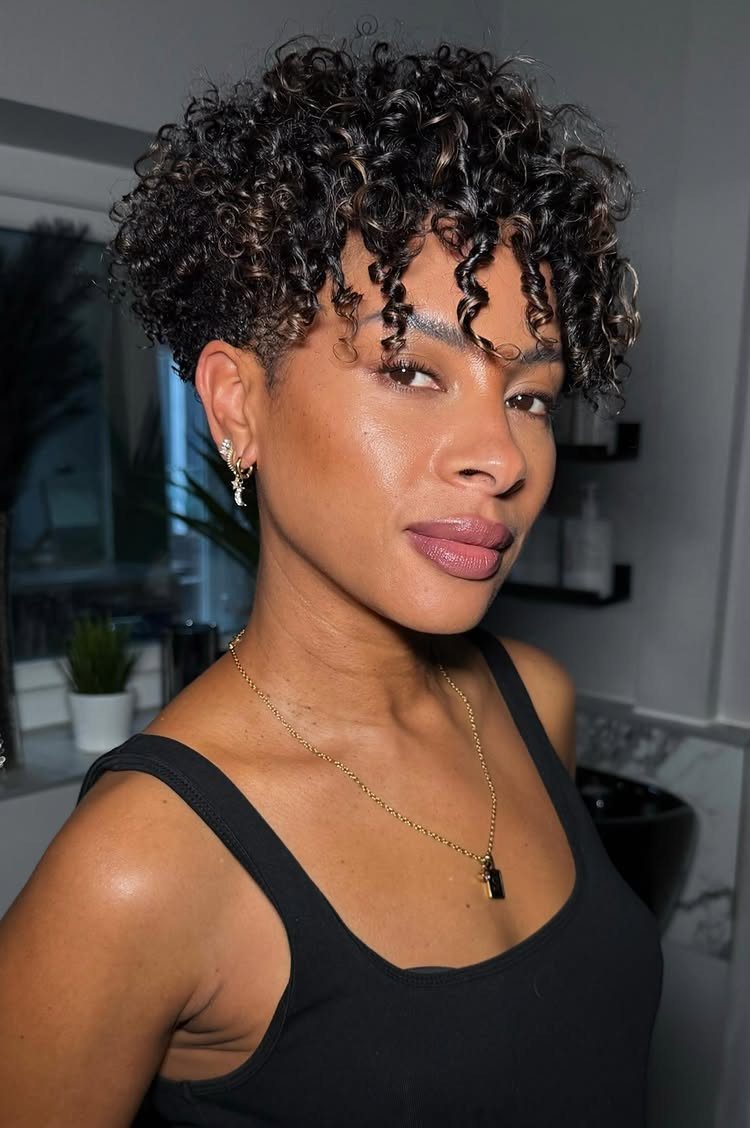 Curly Hair Design: 10 Ideas for Every Length and Texture 7 Woman with a short tapered curly haircut wearing a black tank top