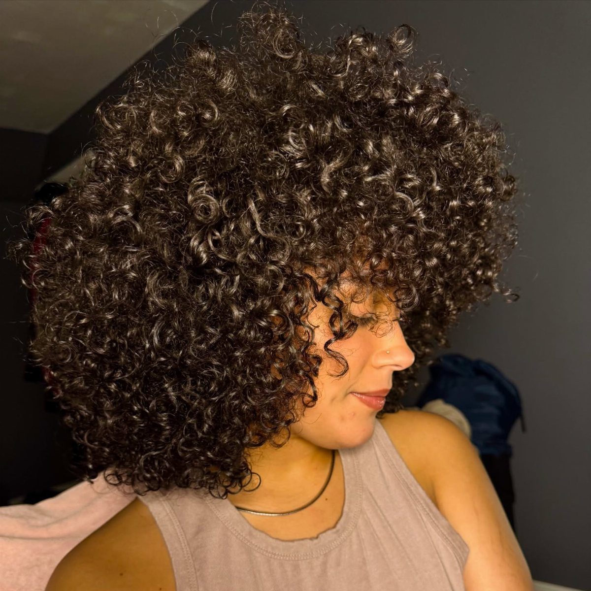 Curly Hair Design: 10 Ideas for Every Length and Texture 10 Woman with voluminous, tightly coiled natural curly hair in a wash-and-go style.