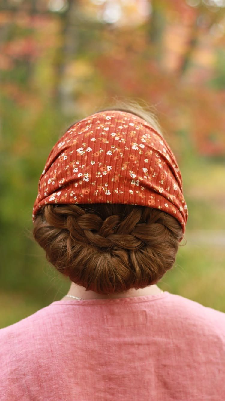 11 Cute Easy Work Hairstyles for Busy Mornings 3 Braided bun hairstyle with a red floral headband and pink linen shirt.