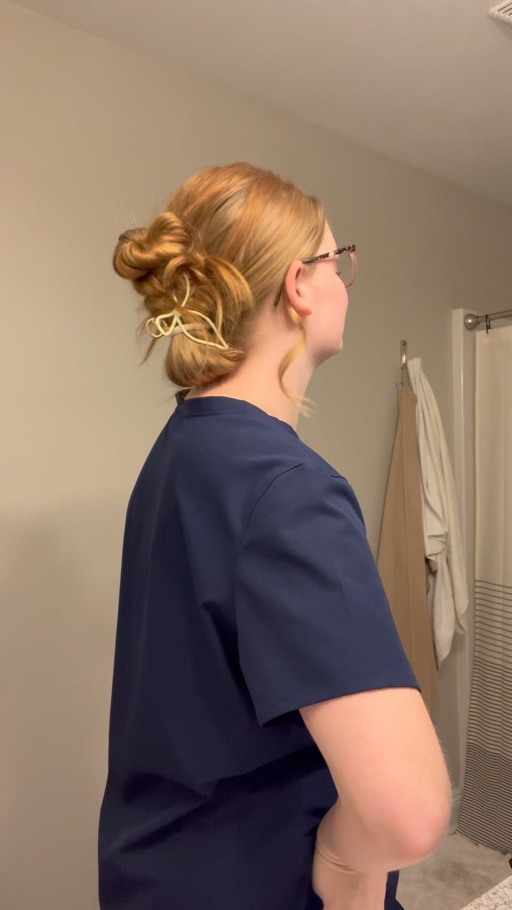 11 Cute Easy Work Hairstyles for Busy Mornings 2 Woman with strawberry blonde hair in a bun secured by a claw clip