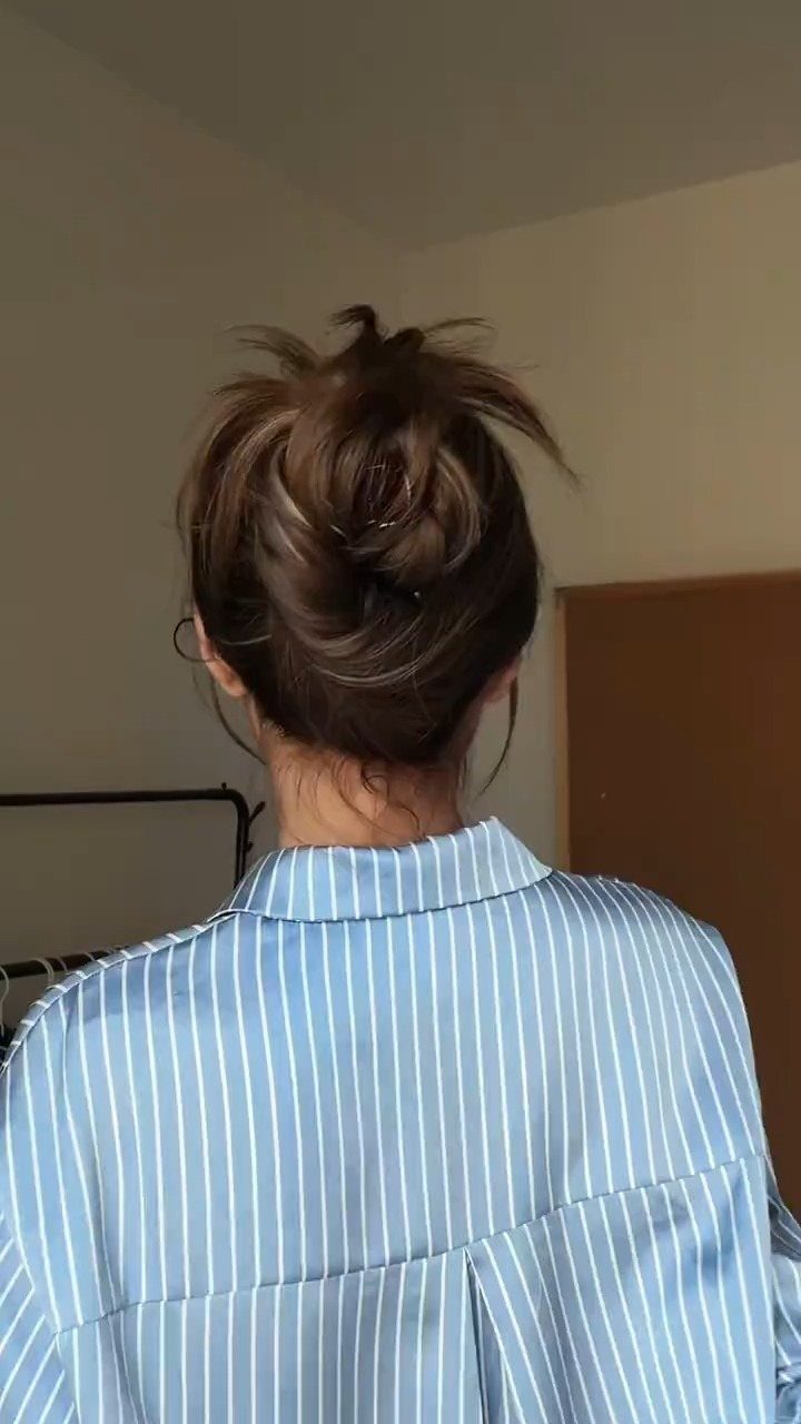 11 Cute Easy Work Hairstyles for Busy Mornings 7 Brown hair styled in a messy bun with a blue striped shirt