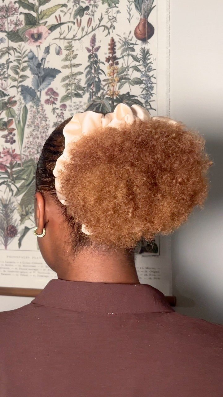 11 Cute Easy Work Hairstyles for Busy Mornings 11 Curly brown hair styled in a high puff secured with a light scrunchie.