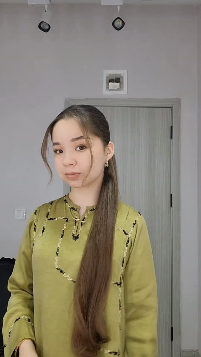 11 Cute Easy Work Hairstyles for Busy Mornings 9 Woman with long sleek straight brown hair wearing a green embroidered tunic.