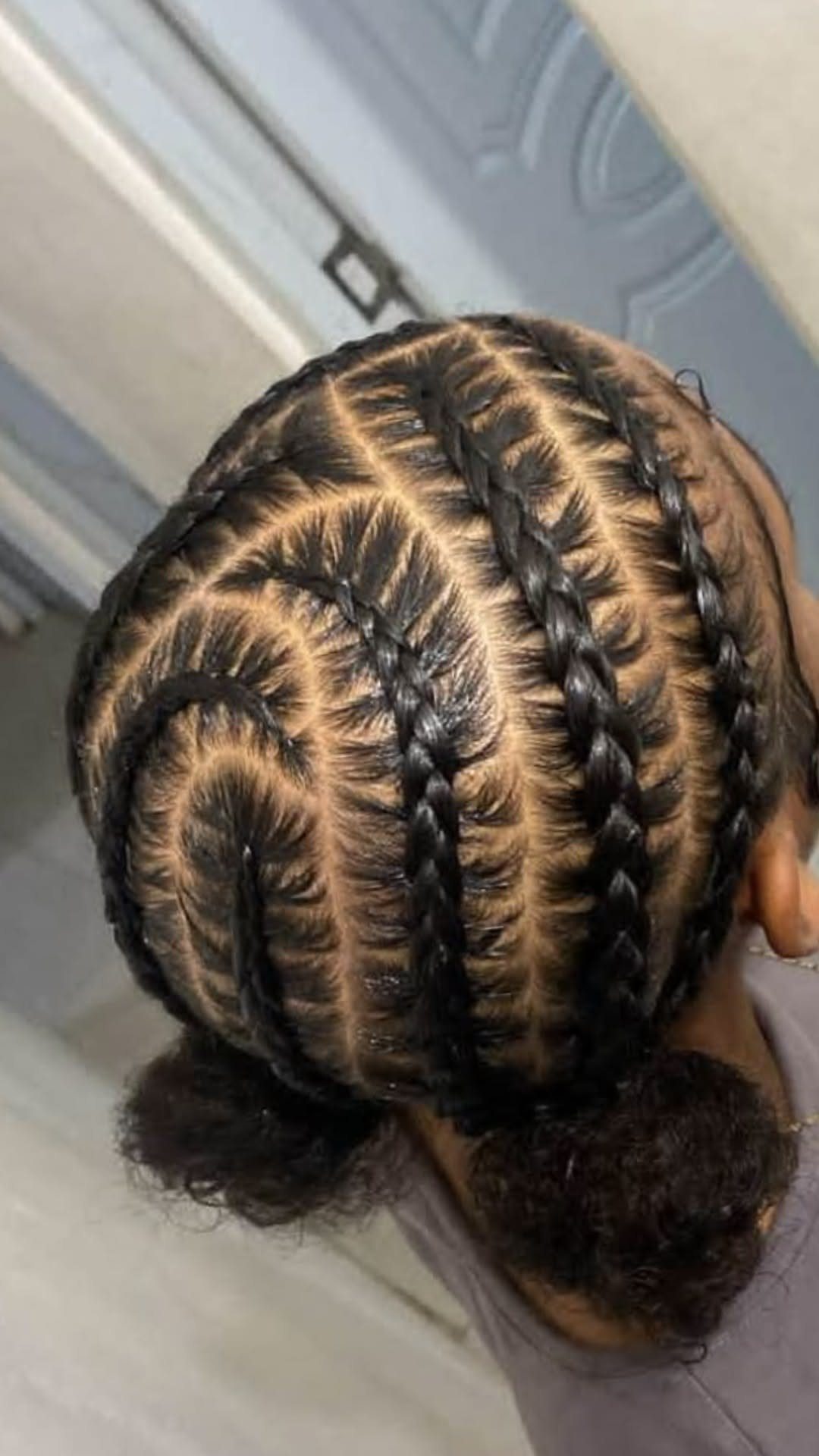 9 Cute Hair Styles for Church, From Buns to Box Braids 7 Cornrow braids on dark hair ending in two low curly buns.